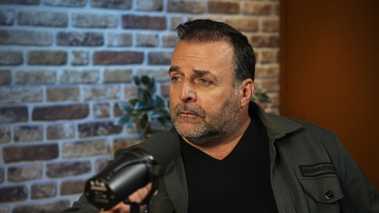 Gast luistert aandachtig achter de microfoon in de studio